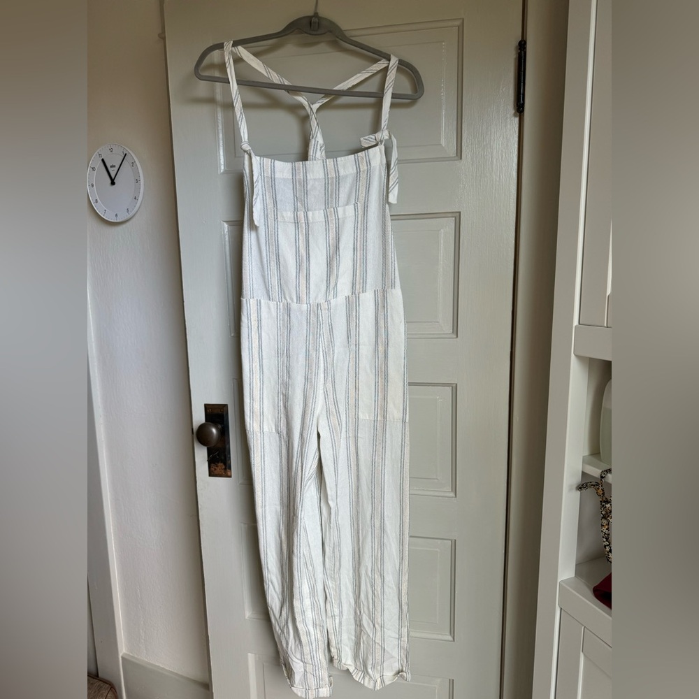 Beautiful romper with details like tied straps and slightly metallic striping.
